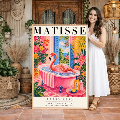 A vertical maximalist art print styled as a Henri Matisse exhibition poster. A vibrant pink flamingo with its long neck curved sits elegantly in a pink clawfoot bathtub. The bathroom features pink tiled floors and walls, with open blue shutters in the background looking out to the sea. The room is filled with tropical greenery and bright pink and orange flowers. A small pink table in the foreground holds soap and cosmetic bottles.