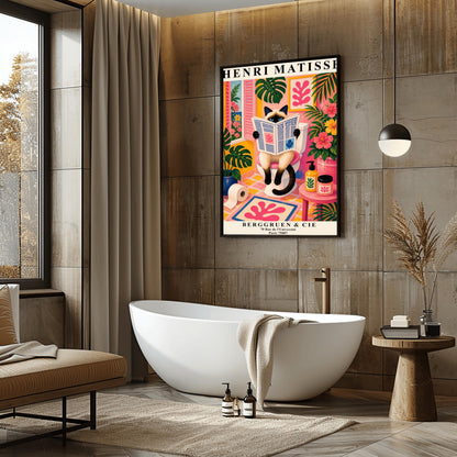A vertical maximalist art print designed as a Henri Matisse exhibition poster. A cream-colored Siamese cat with dark brown points and blue eyes sits on a toilet, holding and reading a newspaper. The bathroom is vibrantly colored with pink walls, yellow and pink checkered tiles, and lush green monstera plants. A window with pink shutters looks out onto a blue sea. A pink bath mat with a leaf cut-out design and colorful soap jars add to the eclectic decor.