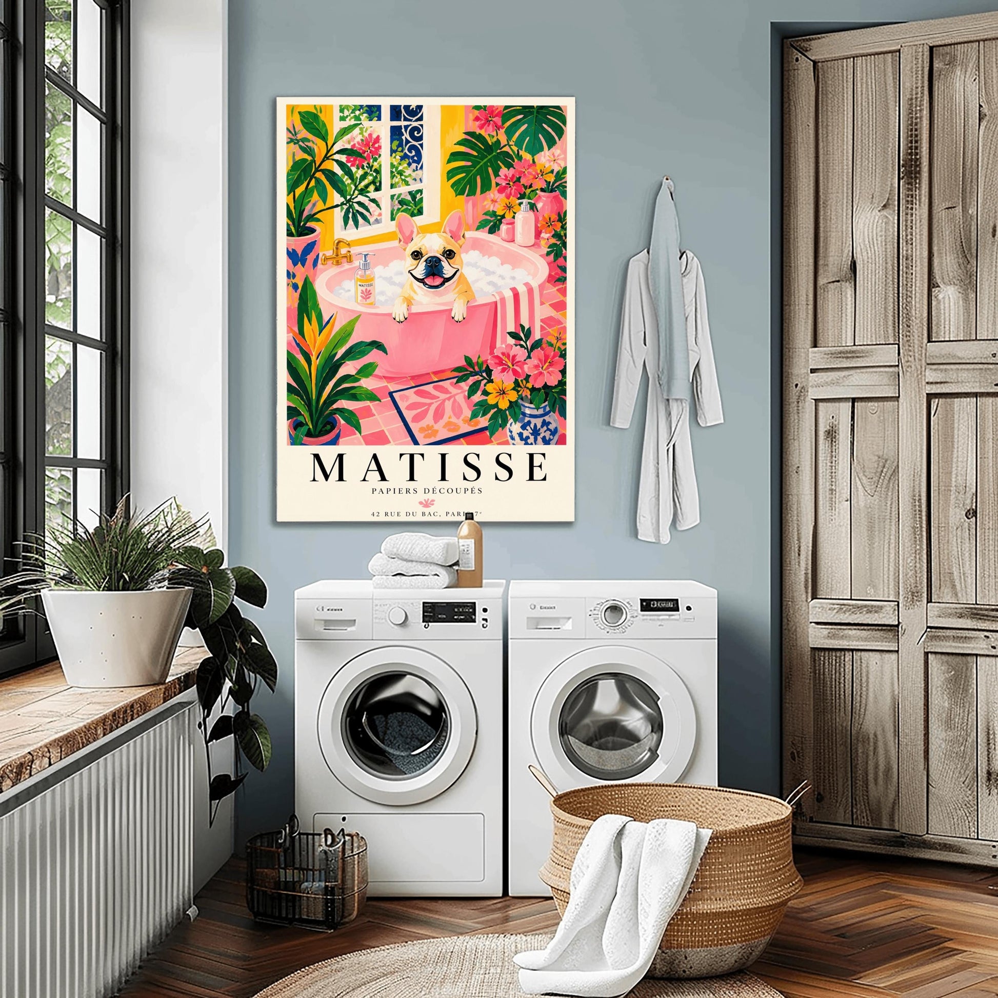 A vertical maximalist art print styled as a Henri Matisse exhibition poster. A tan and white French Bulldog with a wide, happy smile sits in a pink bathtub filled with white bubbles. The bathroom is vibrant with pink tiled floors, yellow walls, and a large window looking out onto a garden. The scene is filled with tropical plants like Monstera and Birds of Paradise. Bold black text at the bottom reads "MATISSE PAPIERS DÉCOUPÉS" with a Paris gallery address.