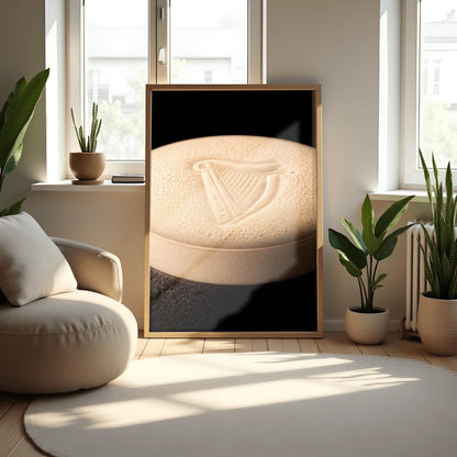 A vertical macro photograph of the thick, creamy foam head on a pint of Guinness. The iconic Guinness harp is embossed into the center of the velvety bubbles. The image features warm cream tones against a dark, shadowy background.