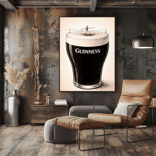A vertical charcoal-style illustration of a pint of Guinness. A tiny silhouette of a person balances on a tightrope stretched across the white foam at the top of the glass. The body of the beer is deep black with the word "GUINNESS" in white. The background is a light, textured cream.