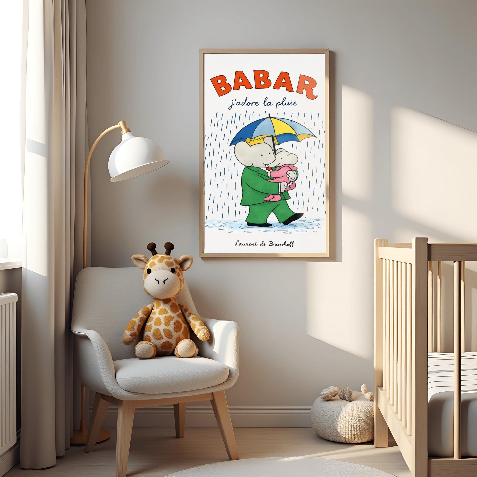 A vertical children's illustration poster titled "BABAR: j'adore la pluie" in orange and blue. King Babar, in a green suit and crown, is walking through the rain while holding a blue and yellow striped umbrella. He is carrying a small elephant wearing a pink rainsuit. They are walking through light blue puddles on a white background. The name "Laurent de Brunhoff" is at the bottom.