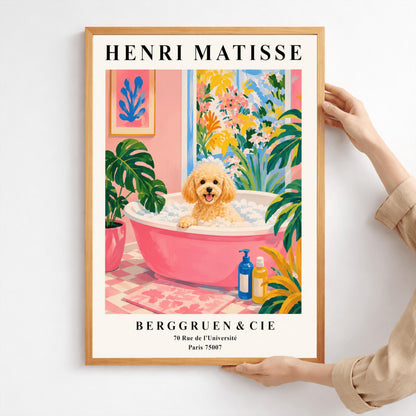 A vertical fine art exhibition poster in the style of Henri Matisse featuring a wide cream border. Bold black text reads "HENRI MATISSE" at the top and "BERGGRUEN & CIE" with a Parisian address at the bottom. The central painting shows an apricot toy poodle dog sitting in a pink bubble bath surrounded by a pink checkered floor, a monstera plant, and a large window overlooking colorful yellow and pink garden plants.
