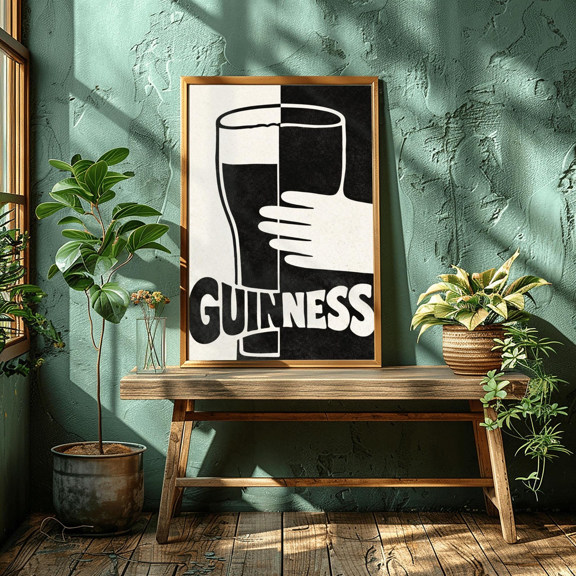A vertical minimalist graphic split down the center: the left half is cream and the right half is black. A large Guinness pint in the center reverses its colors across the split. A white hand holds the glass from the right. The word "GUINNESS" at the bottom also reverses colors across the divide.