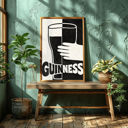 A vertical minimalist graphic split down the center: the left half is cream and the right half is black. A large Guinness pint in the center reverses its colors across the split. A white hand holds the glass from the right. The word "GUINNESS" at the bottom also reverses colors across the divide.