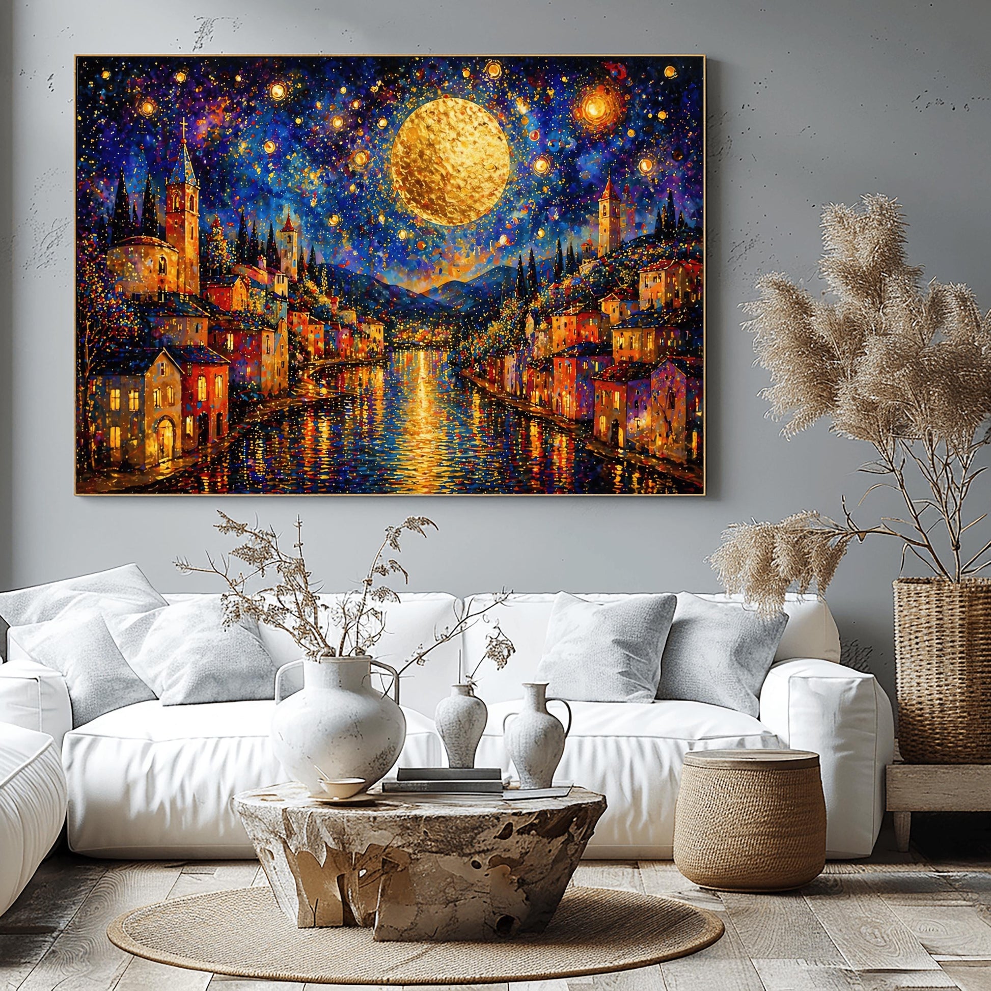 A horizontal art print in a decorative mosaic style inspired by Gustav Klimt. A coastal town with warm-lit houses and tall church towers lines both sides of a dark blue canal. A massive, glowing golden moon hangs in a deep indigo sky filled with swirling stars and shimmering golden circles. The lights of the town and the moon reflect brilliantly on the rippling water. The entire scene is composed of intricate, sparkling patterns and vibrant jewel-toned colors.