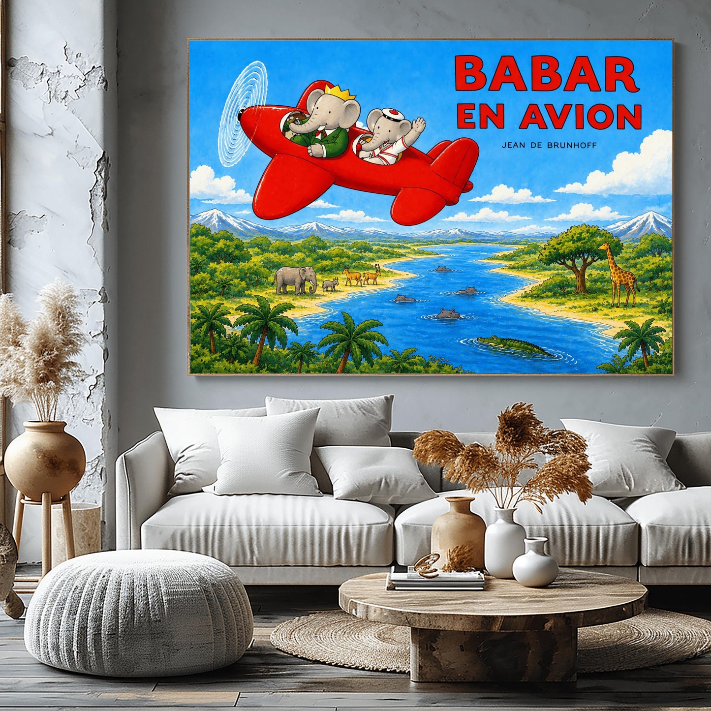 A horizontal watercolor-style illustration of Babar the Elephant flying a bright red propeller plane. Babar wears a green suit and crown, while a smaller elephant in a white sailor suit waves from the back seat. They fly over a vibrant safari landscape with a winding blue river filled with hippos and a crocodile. On the riverbanks are giraffes, antelopes, elephants, and palm trees. Snow-capped mountains rise in the distance under a blue sky. Large red text reads "BABAR EN AVION."