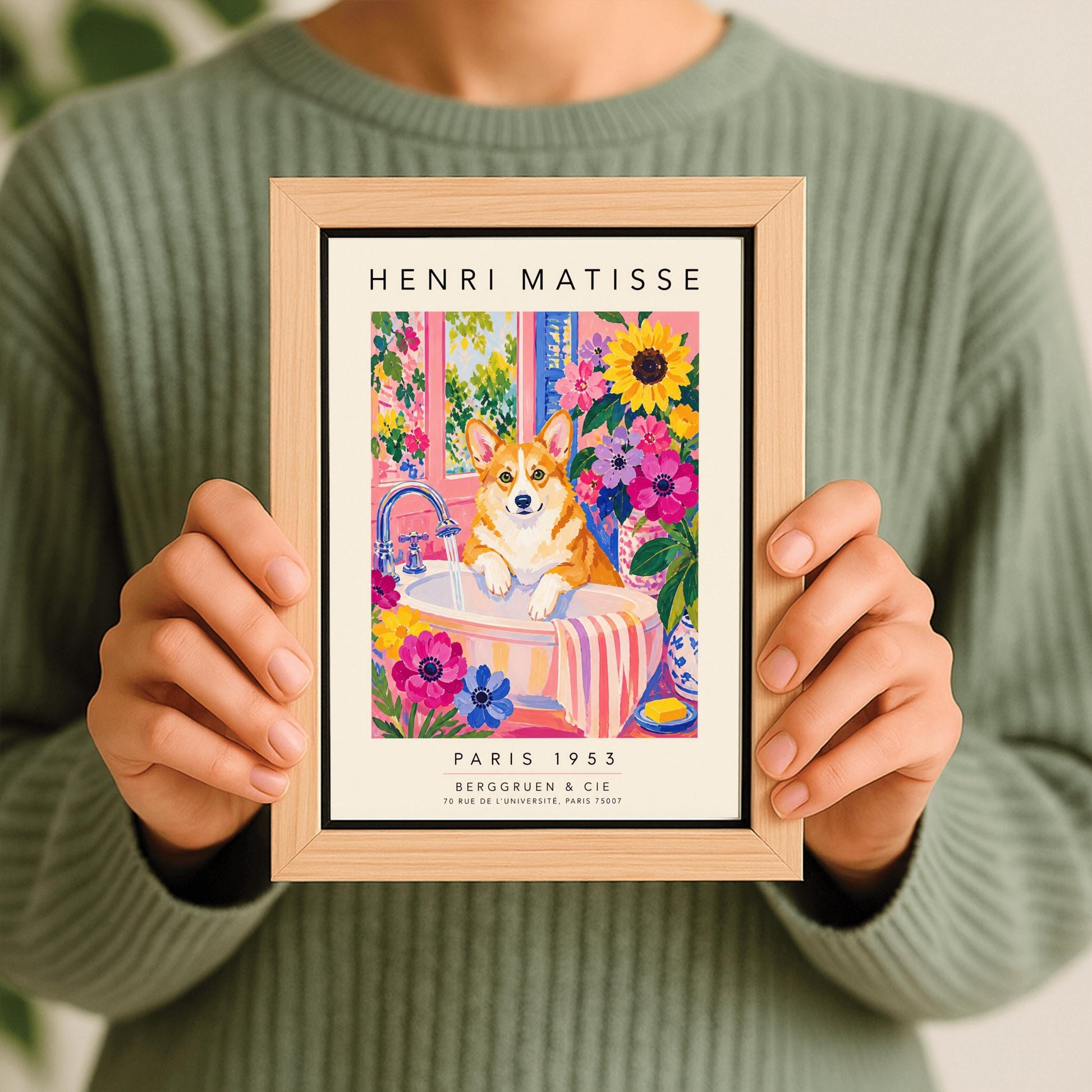A vertical maximalist art print styled as a Henri Matisse exhibition poster. A tan and white Pembroke Welsh Corgi dog with large ears stands in a white bathroom sink under a running silver faucet. The room features pink walls and is filled with large sunflowers and pink and purple blossoms. A pink and white striped towel hangs from the side of the sink. A window in the background looks out onto a leafy green garden. Bold black text at the top and bottom
