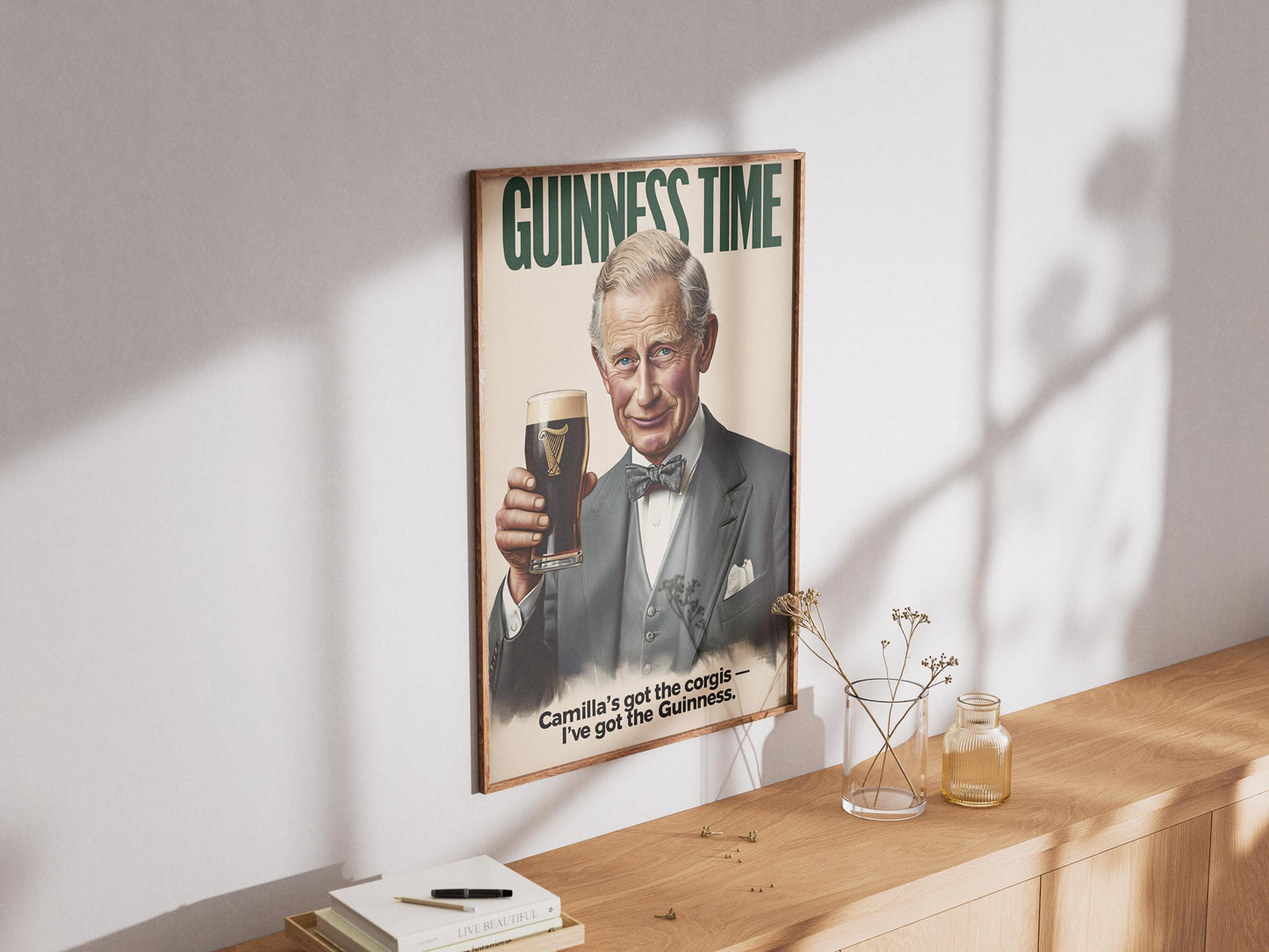 A humorous art print featuring King Charles III holding a classic pint of Guinness. The illustration shows him smiling with the iconic dark stout and creamy head. The text 'GUINNESS TIME' appears at the top, and 'Camilla's got the corgis — I've got the Guinness.' at the bottom, adding a witty royal touch. This unique print is ideal for pub or bar decor, a man cave, or as a quirky gift for fans of the British Royal Family and Guinness beer, blending humor with an iconic beverage