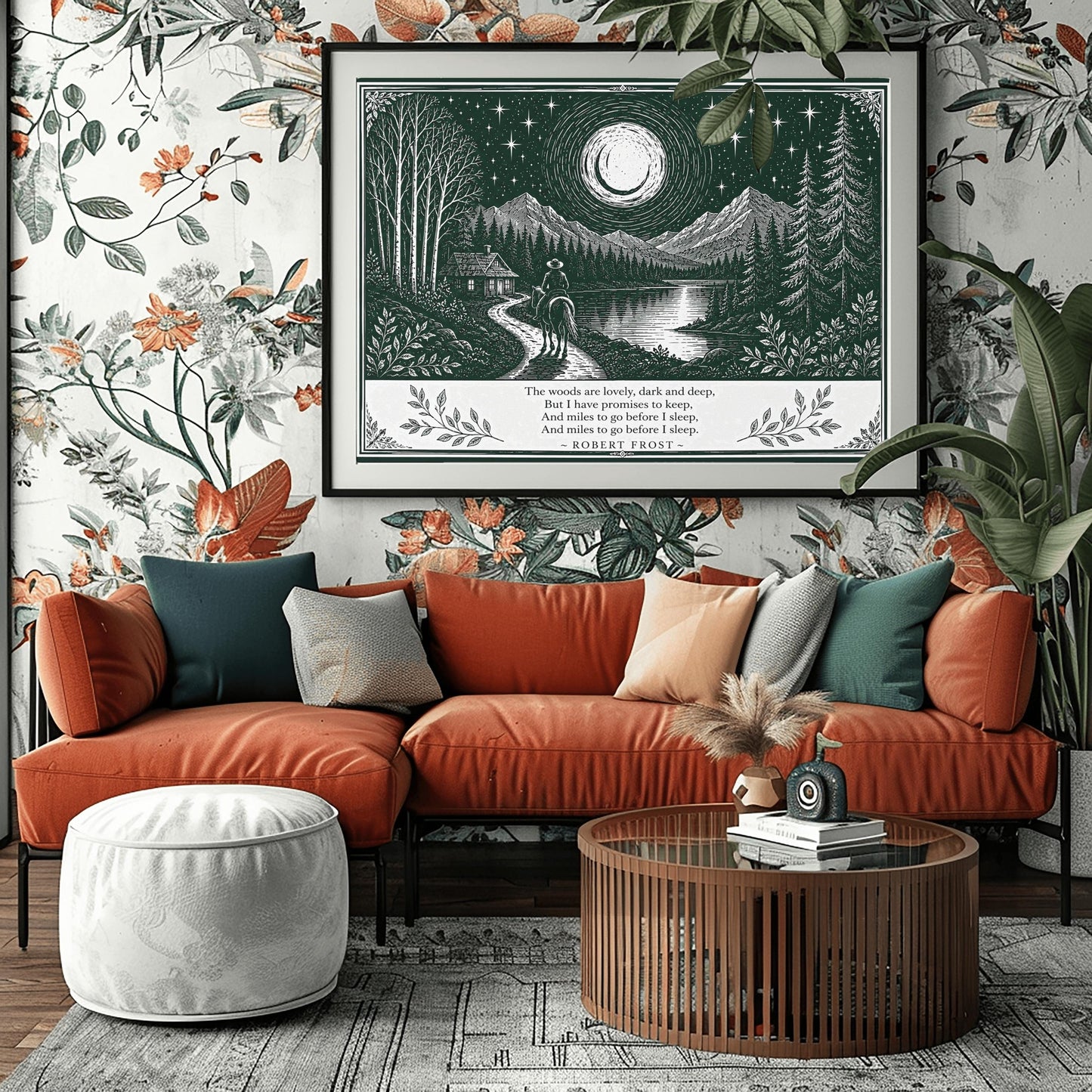 A wide horizontal art print in forest green and cream. A person on horseback follows a path toward a small cabin by a lake. In the background are tall pine forests and sharp mountain peaks under a massive moon and starry sky. The bottom of the print contains four lines of Robert Frost’s poetry in clean serif text, flanked by simple leaf illustrations.