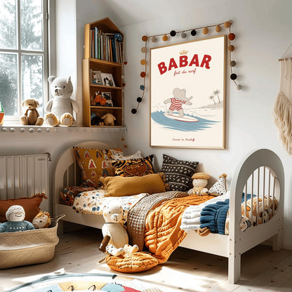 A vertical storybook-style art print of Babar the Elephant surfing. Babar is wearing a red and white striped swimsuit and standing on a white surfboard with a red stripe. He is riding a blue wave with a white crest. In the background, there is a tan beach with two palm trees under a cream sky. The top reads "BABAR fait du surf" with a small gold crown.