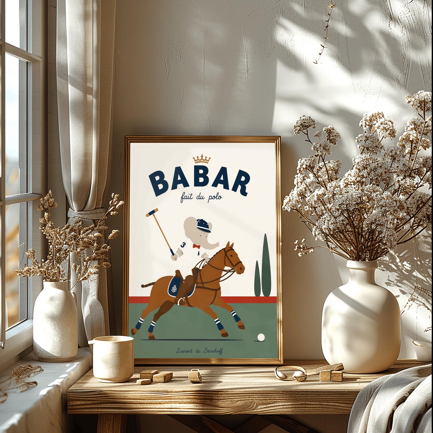 A vertical storybook-style art print of Babar the Elephant playing polo. Babar is riding a chestnut brown horse, wearing a white jersey with the number 3, a red bow tie, and a navy riding helmet. He holds a polo mallet in one hand. The horse has navy and white striped leg wraps. The background features a green field, a red horizon line, and two green cypress trees under a cream sky. The top reads "BABAR fait du polo" with a gold crown.