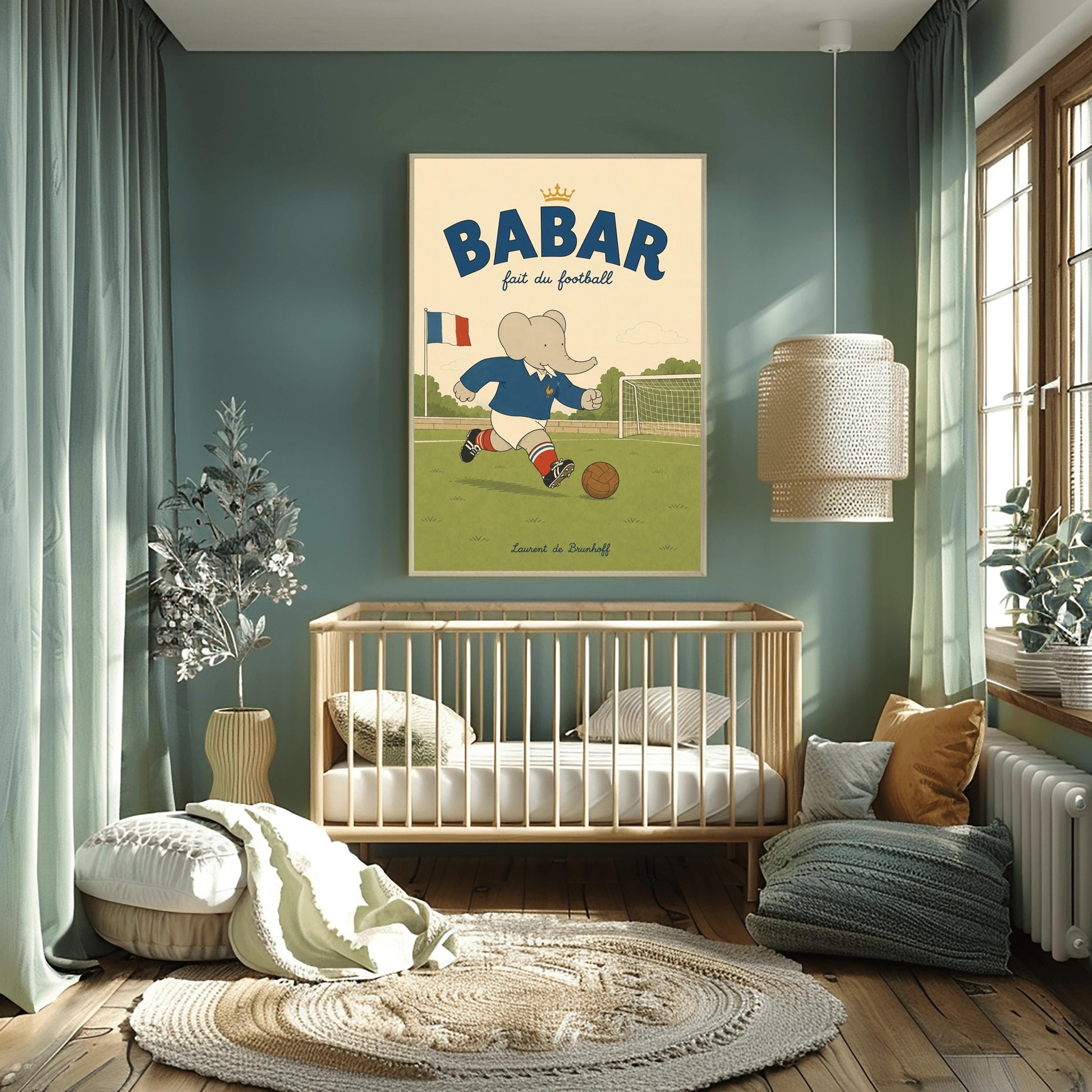 A vertical storybook-style art print featuring Babar the Elephant playing soccer on a green field. Babar wears a blue jersey with a small gold rooster logo, white shorts, red striped socks, and black cleats. He is dribbling a brown leather soccer ball toward a white goal. A French flag flies in the background. The text at the top says "BABAR fait du football" with a small gold crown.