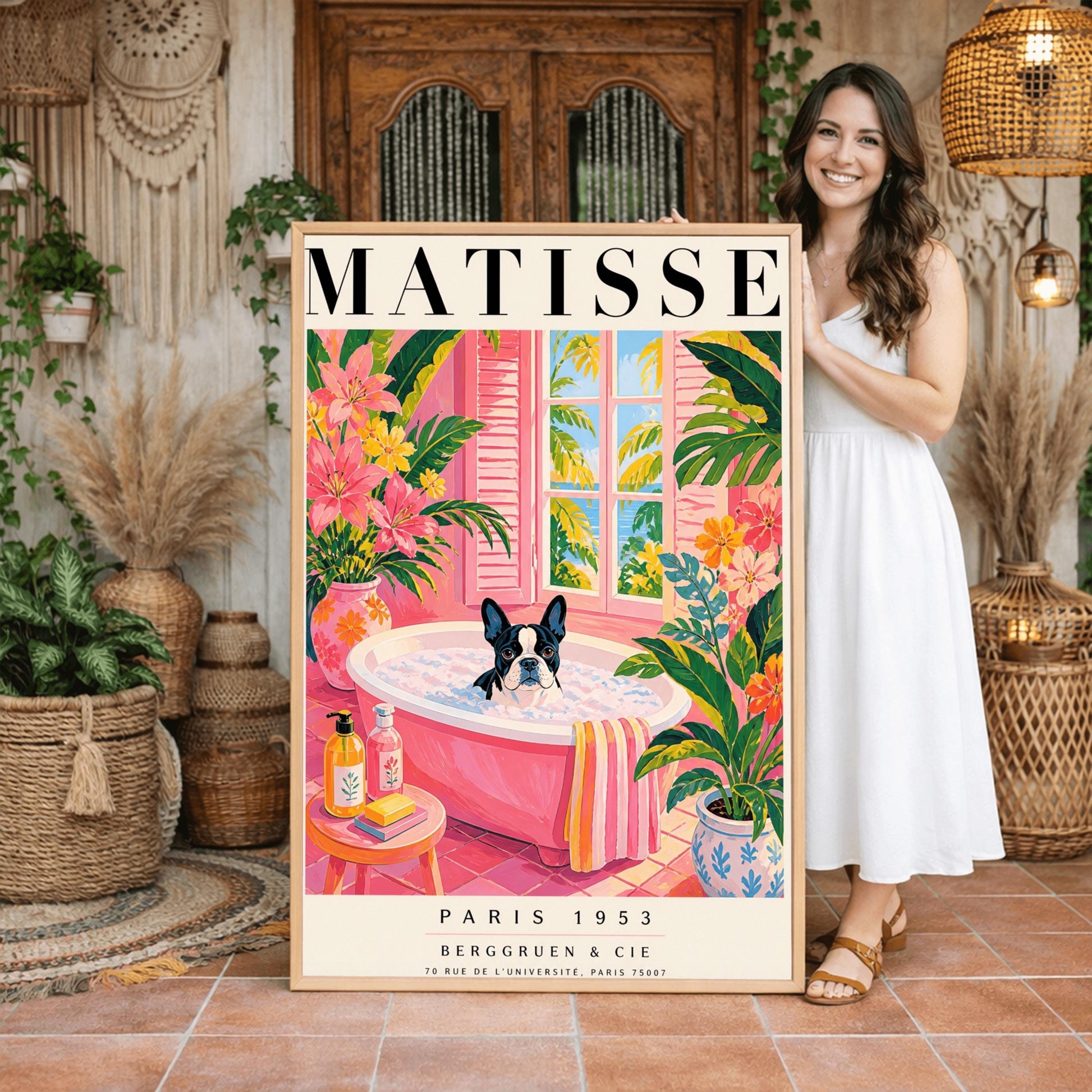 A vertical maximalist art print styled as a Henri Matisse exhibition poster. A black and white Boston Terrier dog sits in a pink bathtub filled with white bubbles. The bathroom features pink tiled floors and walls, decorated with lush green tropical plants and vibrant pink flowers in floral vases. A window with pink shutters in the background looks out onto palm trees and a blue ocean. In the foreground, soap bottles and a yellow bar of soap sit on a small pink stool.