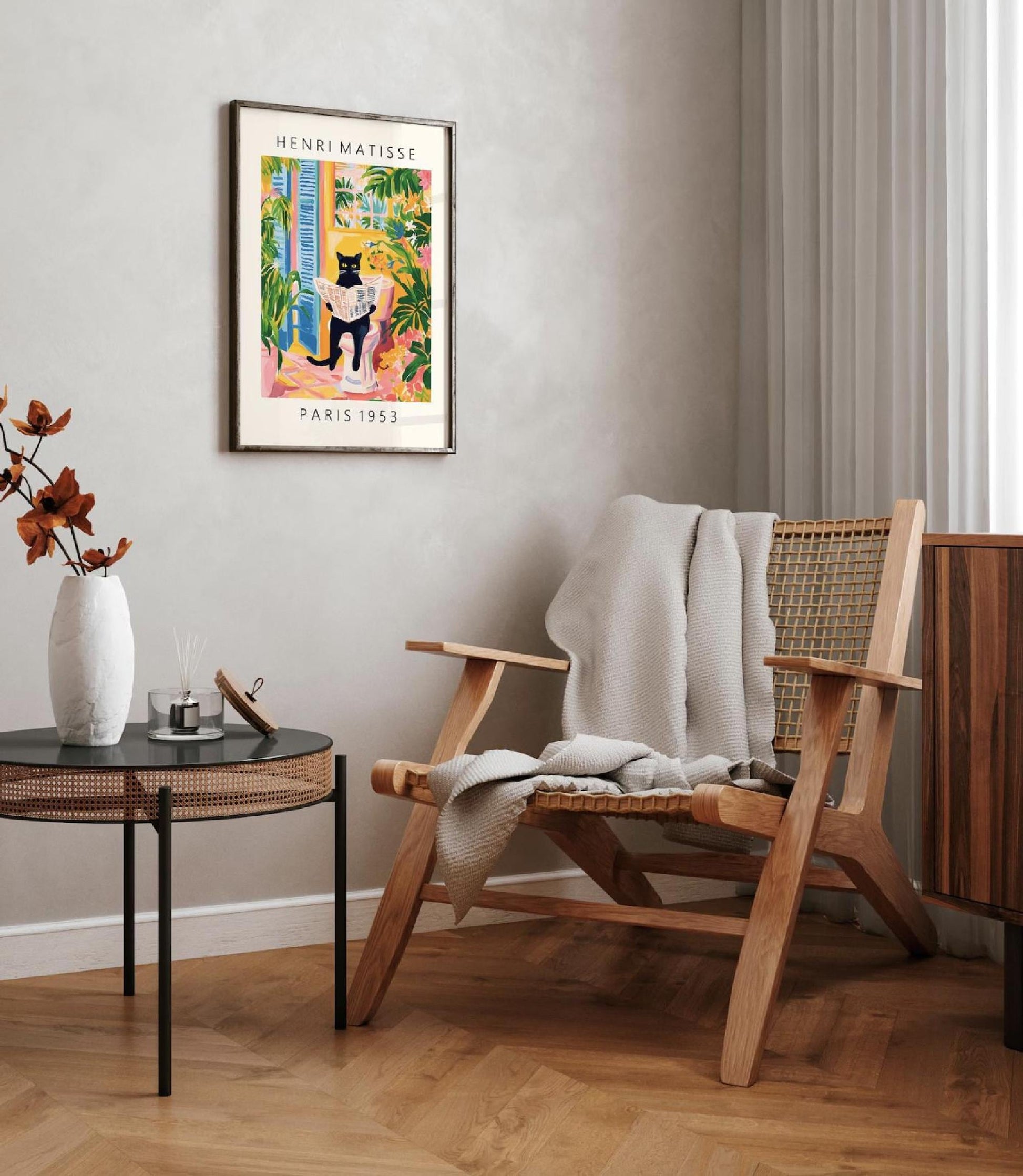 Wooden chair with a blanket draped over it in a room with a framed poster on the wall.
