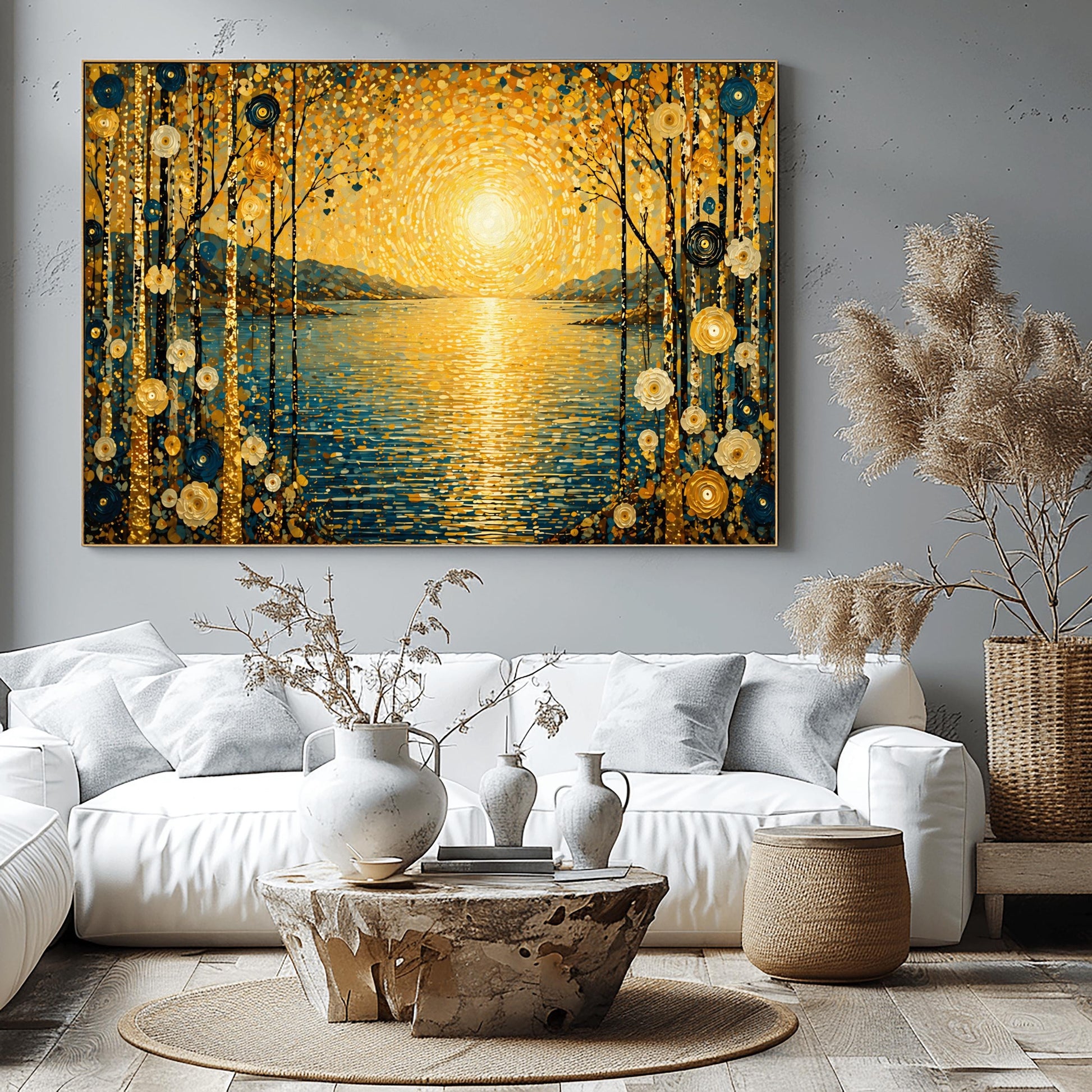 A horizontal art print in a decorative mosaic style inspired by Gustav Klimt. A large, radiant golden sun composed of shimmering circles hangs over a calm blue lake, with its light reflecting on the water's surface. The scene is framed on both sides by tall, thin birch trees decorated with stylized gold and cream flowers. Muted blue mountains are visible in the background under a sky filled with golden, dappled light patterns.