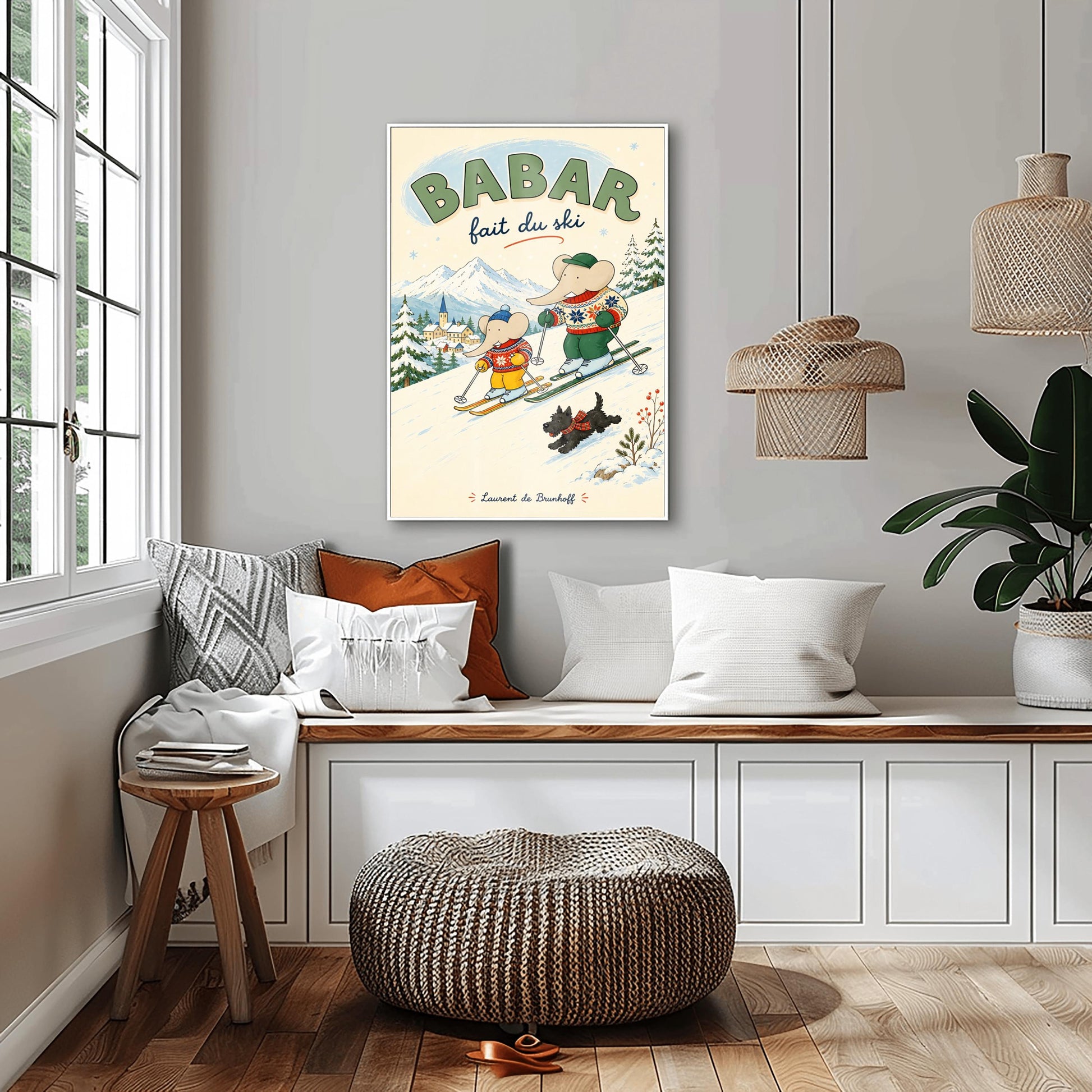 A vertical retro fine art exhibition poster titled "BABAR fait du ski" on a wide cream border. The illustration shows a large elephant and a small elephant skiing down a snowy slope wearing colorful patterned winter sweaters, accompanied by a small black dog in a plaid scarf. A snow-covered village and mountains are visible in the background, with the name "Laurent de Brunhoff" printed at the bottom.