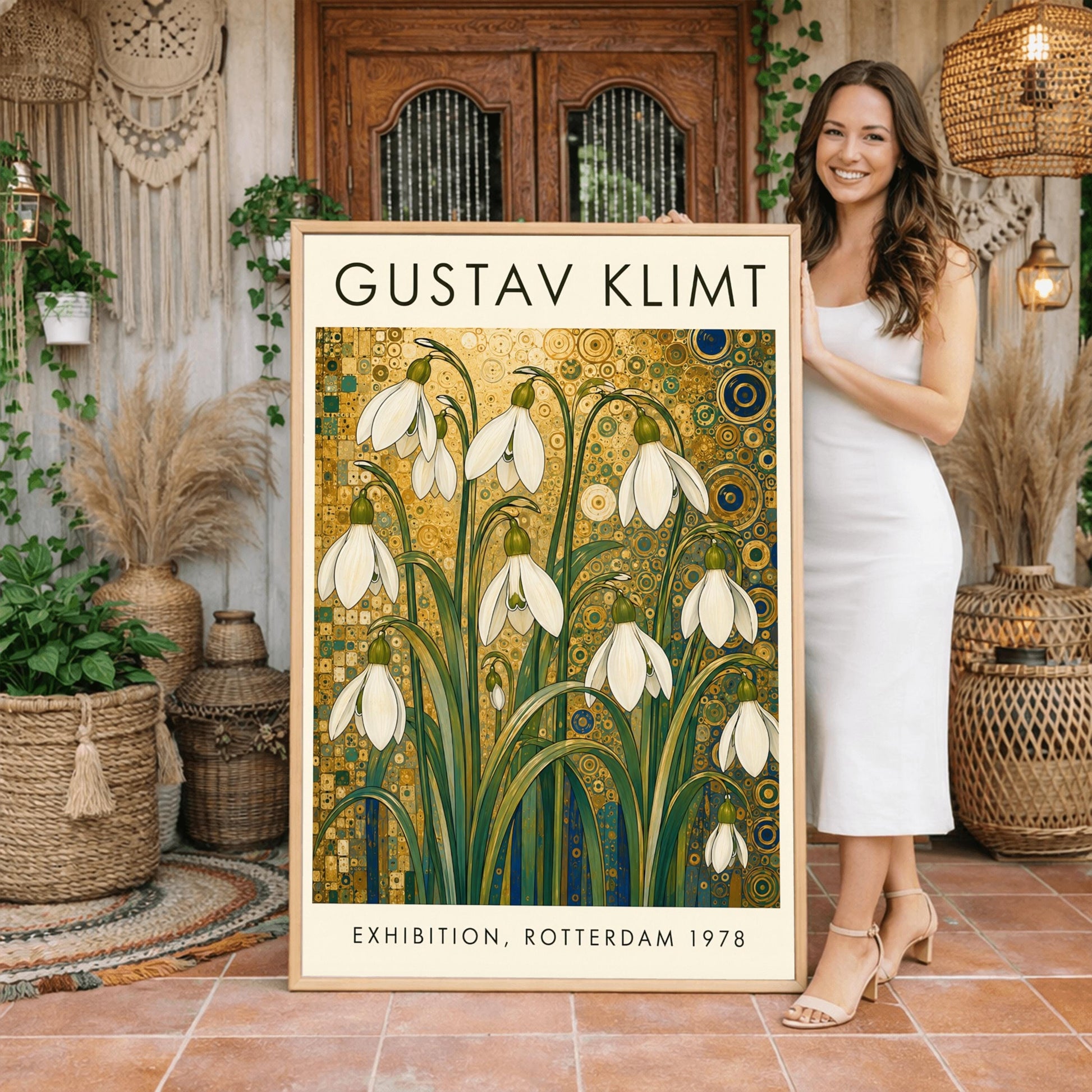 A vertical retro exhibition poster for Gustav Klimt featuring a wide cream-colored border. The central image shows an intricate Art Nouveau illustration of a cluster of delicate white snowdrop flowers with long green leaves reaching upward. The background is an opulent, decorative tapestry of metallic gold patterns, featuring detailed concentric circles, swirling spirals, and tiny mosaic tiles accented with hints of blue and teal.