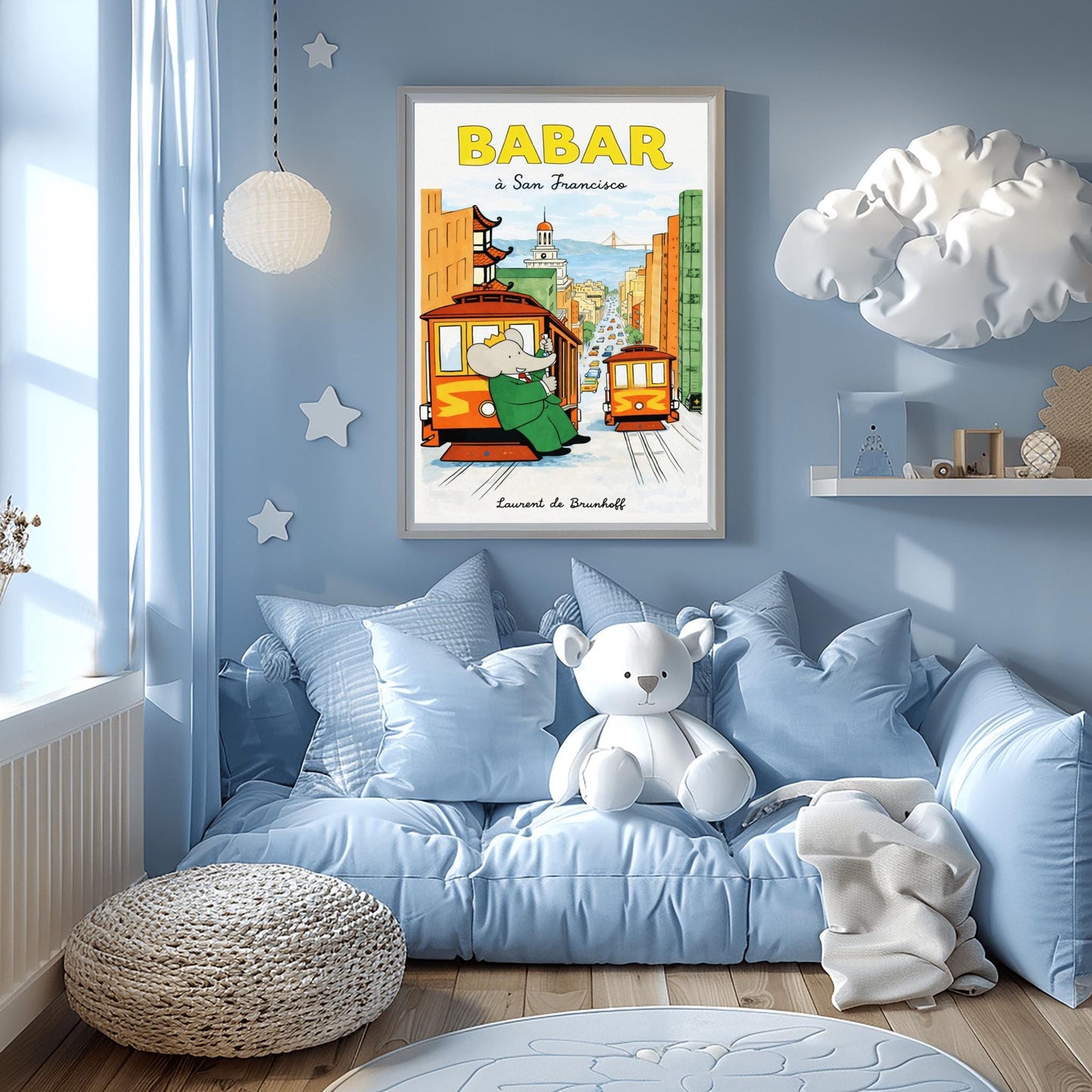 A vertical children's illustration poster titled "BABAR: j'adore la pluie" in orange and blue. King Babar, in a green suit and crown, is walking through the rain while holding a blue and yellow striped umbrella. He is carrying a small elephant wearing a pink rainsuit. They are walking through light blue puddles on a white background. The name "Laurent de Brunhoff" is at the bottom.