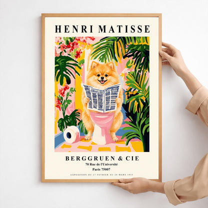 A vertical fine art exhibition poster in the style of Henri Matisse featuring a wide cream border. Bold black text reads "HENRI MATISSE" at the top and "BERGGRUEN & CIE" at the bottom. The central painting humorously depicts a fluffy orange Pomeranian dog smiling while sitting on a pink toilet reading a newspaper, surrounded by lush green palm leaves, tropical flowers, and a toilet paper roll on the floor.