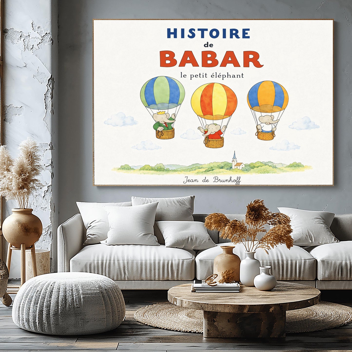 A whimsical vintage-style storybook poster on a clean white background titled "HISTOIRE de BABAR le petit éléphant" in bold blue and orange lettering. The illustration features three cartoon elephants floating in striped hot air balloons over a light green watercolor countryside with a white church steeple. On the left, King Babar in a green suit and crown waves from a blue-and-green balloon. In the center, an elephant in a red dress sits in a yellow-and-orange balloon.