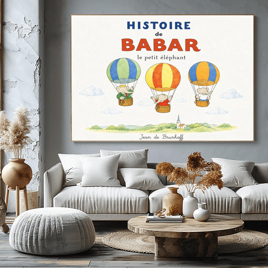 A whimsical vintage-style storybook poster on a clean white background titled "HISTOIRE de BABAR le petit éléphant" in bold blue and orange lettering. The illustration features three cartoon elephants floating in striped hot air balloons over a light green watercolor countryside with a white church steeple. On the left, King Babar in a green suit and crown waves from a blue-and-green balloon. In the center, an elephant in a red dress sits in a yellow-and-orange balloon.