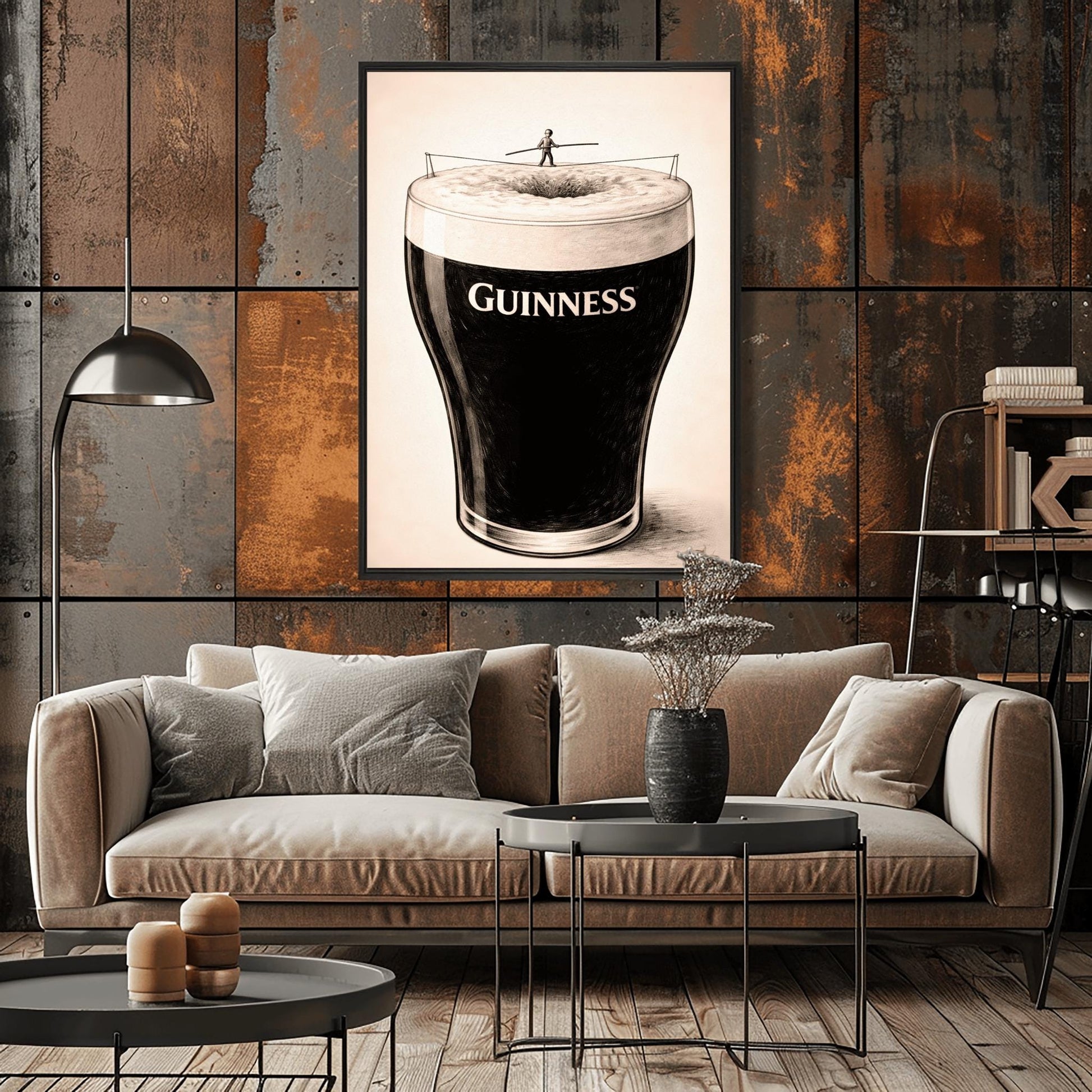 A vertical charcoal-style illustration of a pint of Guinness. A tiny silhouette of a person balances on a tightrope stretched across the white foam at the top of the glass. The body of the beer is deep black with the word "GUINNESS" in white. The background is a light, textured cream.